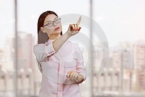 Young asian woman is pointing at invisible virtual.