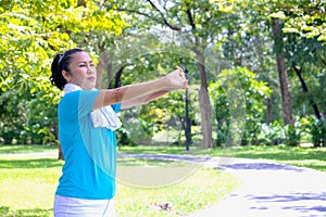 Young Asian woman portrait.She is Jogging in park.