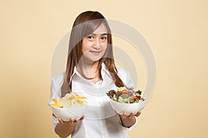 Young Asian woman with potato chips and salad
