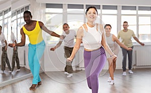 Young Asian woman practicing hip-hop dance in training hall