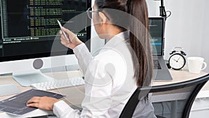 Young Asian woman Programmer Typing code working with computer at table, coding cyberspace and Web Development Concept