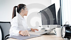 Young Asian woman Programmer Typing code working with computer at table, coding cyberspace and Web Development Concept