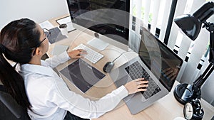 Young Asian woman Programmer Typing code working with computer at table, coding cyberspace and Web Development Concept