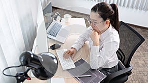 Young Asian woman Programmer Typing code working with computer at table, coding cyberspace and Web Development Concept