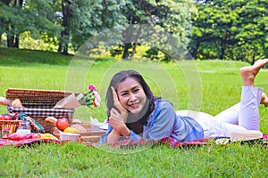 Young Asian woman relax time in park.In the morning she is smile and  laugh