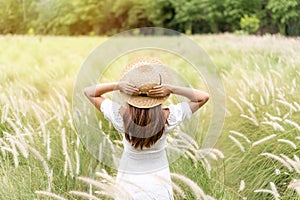 Young asian woman relaxing and enjoying in the flower field while traveling