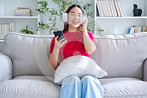 Young Asian woman relaxing on sofa at home