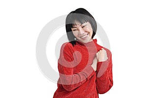 Young asian woman reminiscing about love wearing winter red sweater, isolated.