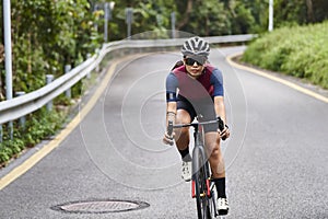 young asian woman riding bike outdoors