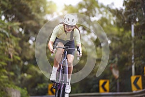 young asian woman riding bike outdoors