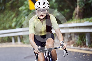 young asian woman riding bike outdoors photo