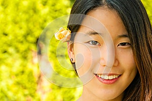 Young Asian Woman Rose Bud in Hair