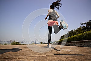 Young asian woman running outdoors