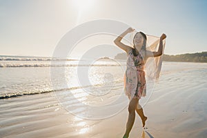 Young Asian woman running and playing on beach, Beautiful female relax on beach near sea when sunset in evening. Lifestyle woman