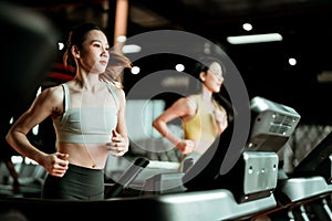 Young Asian Woman Running on Treadmill