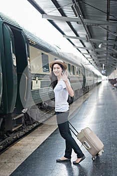 Young Asian woman say goodbye to boyfriend at train station before journey