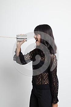 Young Asian woman shout with tin can phone