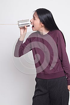 Young Asian woman shout with tin can phone