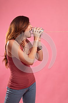 Young Asian woman shout with tin can phone