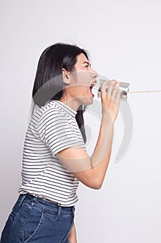 Young Asian woman shout with tin can phone