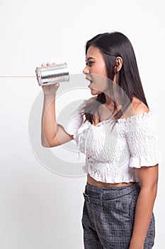 Young Asian woman shout with tin can phone