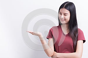 Young asian woman are showing empty hand to put a product