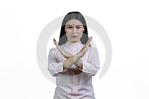 Young asian woman showing stop gesture with crossed hands.