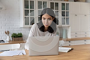 Young Asian woman sit at table working using laptop