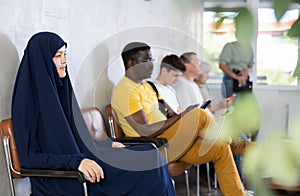 Young asian woman sitting at hall of civil service building