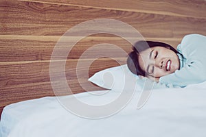 Young asian woman sleeping on bedroom and grinding teeth,Female tiredness and stress photo