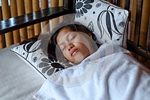 Young Asian woman sleeping peacefully in the balcony during summer vacation