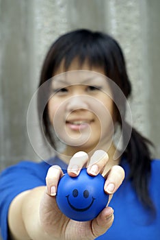 Young asian woman and smiley ball