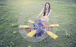 Young asian woman smiling happy and enjoying to play at a playground,selective focus,filtered image,light effect added