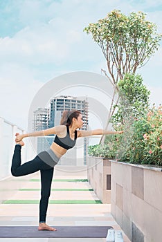 Young asian woman in sport wear doing sports outdoors