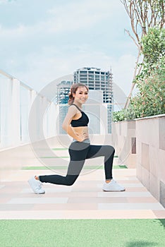 Young asian woman in sport wear doing sports outdoors