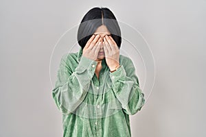 Young asian woman standing over white background rubbing eyes for fatigue and headache, sleepy and tired expression