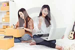 Young Asian woman startup small business entrepreneur SME distribution warehouse with parcel mail box. Owner home office concept.