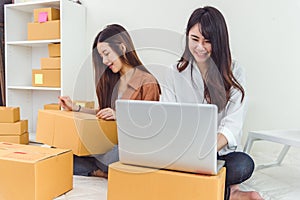 Young Asian woman startup small business entrepreneur SME distribution warehouse with parcel mail box. Owner home office concept.