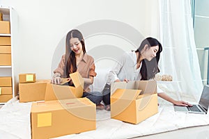 Young Asian woman startup small business entrepreneur SME distribution warehouse with parcel mail box. Owner home office concept.