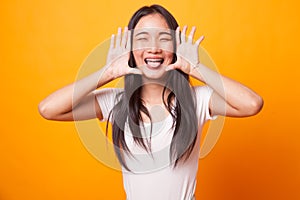 Young Asian woman sticking her tongue out.