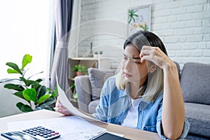 Young Asian woman is stressed because she is looking at many bills and has no money to pay them. Finance concept
