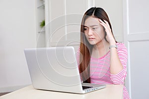 Young asian woman struggle with laptop computer, Frustrated asian girl looking at laptop while working at home, People struggle