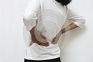 Young asian woman suffering low back pain and waist lumbar pain