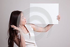 Young Asian woman surprise with white blank sign.