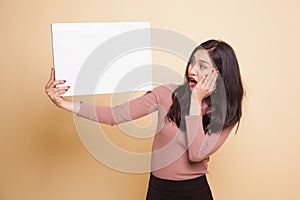 Young Asian woman surprise with white blank sign.