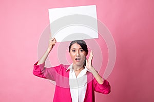 Young Asian woman surprise with white blank sign