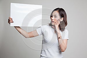 Young Asian woman surprise with white blank sign.