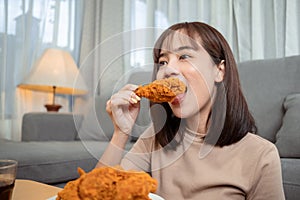 Young asian woman takeaway eating junk food chicken nuggets wing, Female having fun enjoying fast food