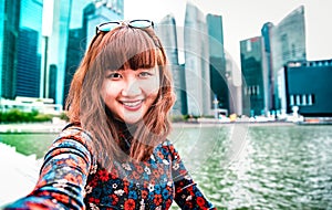 Young asian woman taking happy selfie traveling at Singapore skyline - Wanderlust life style concept with millenial girl