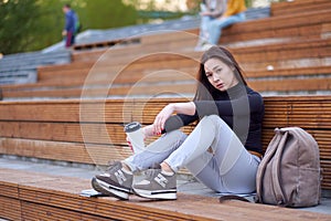 Young asian woman teen with coffee. outdoor city portrait